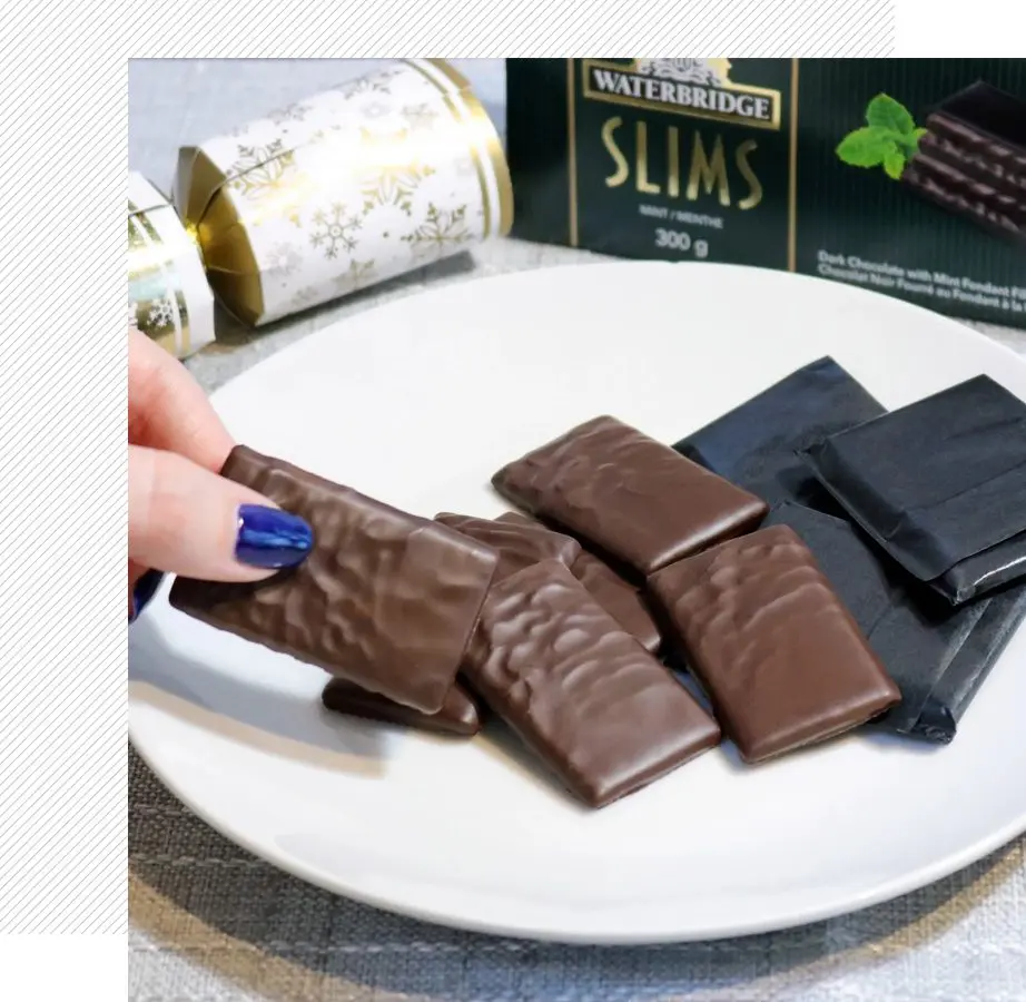 A person is holding onto some chocolate bars
