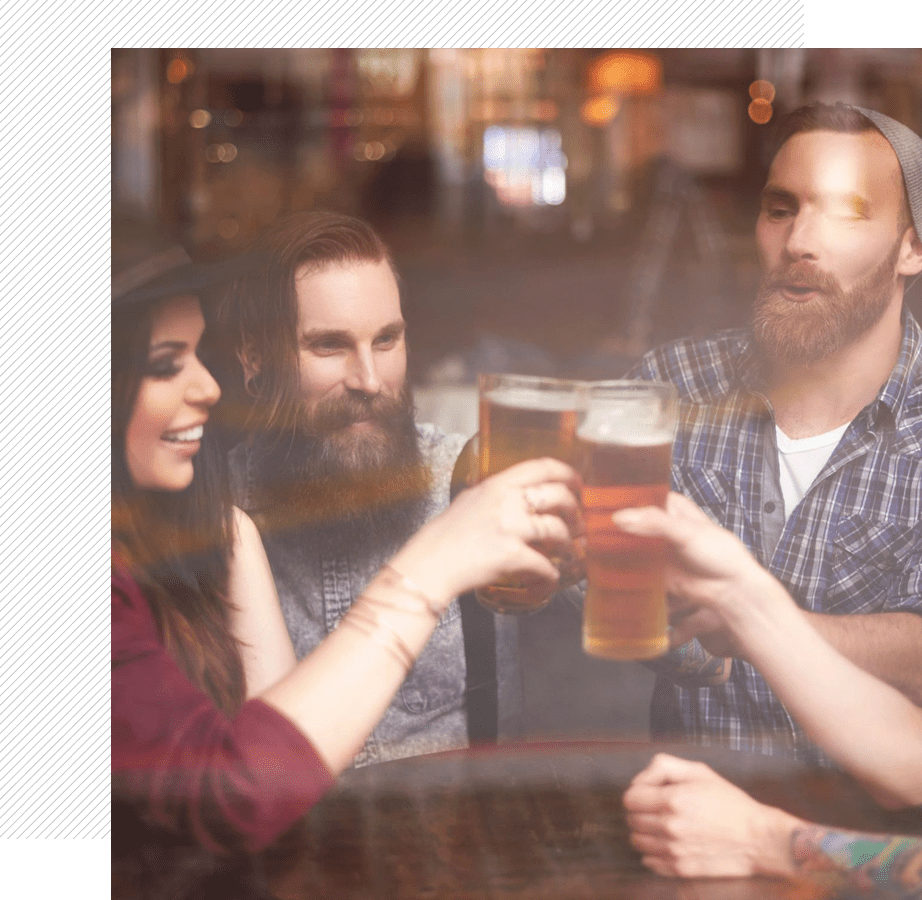 A group of people sitting at a table with drinks.